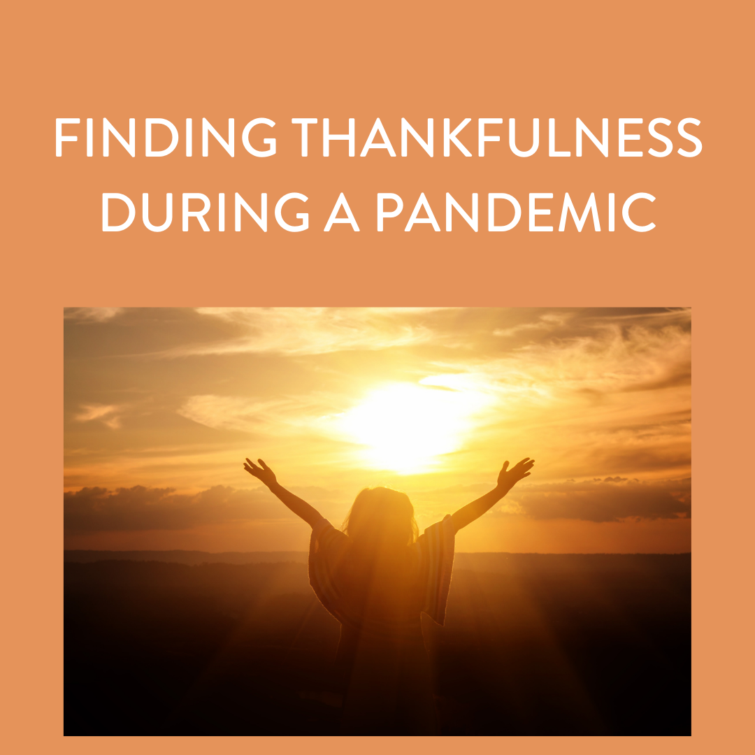 Finding thankfulness text with sunset in the background with someone holding their hands up