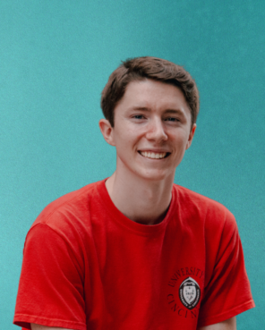 picture of Daniel Rowe in a red shirt with a teal background