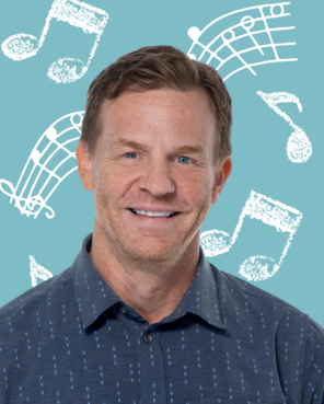 Sean Smith, Sales and Partnerships Manager Headshot of Sean Smith with light blue background with chalk music notes drawings