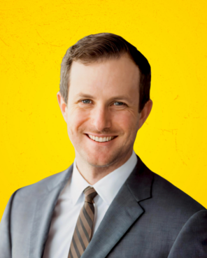 Headshot of Kyle Pendergast with yellow background.